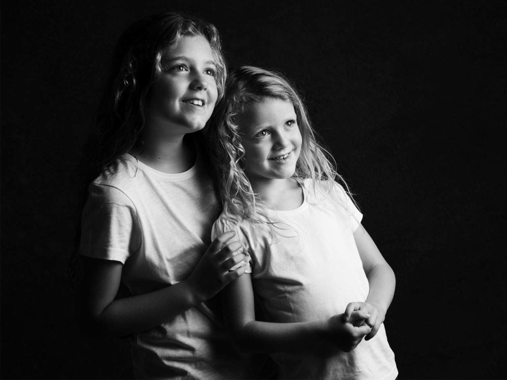 Sisters are posing for portrait