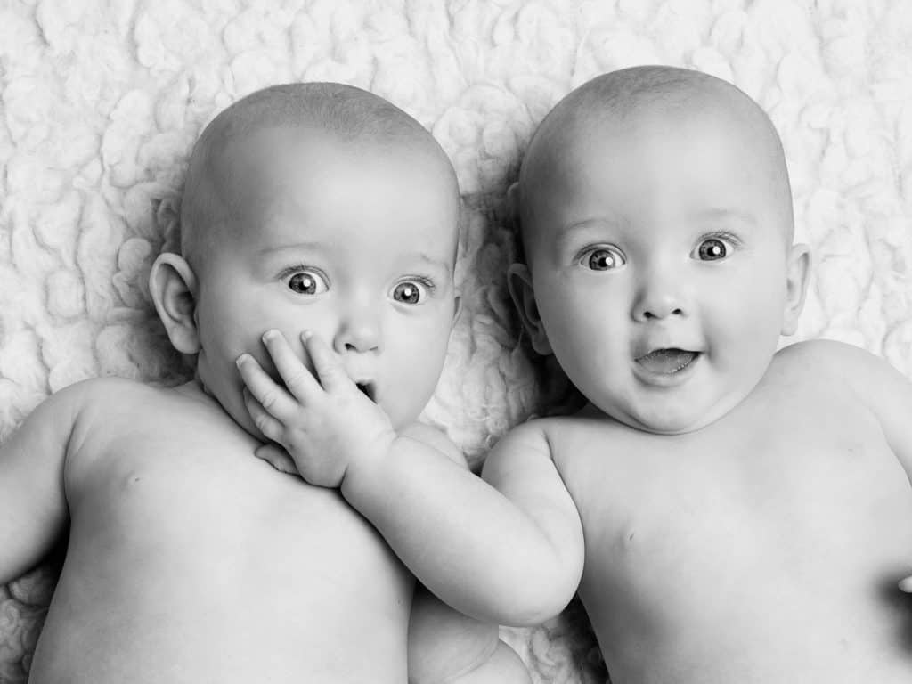 Babies smiling to the camera - studio photo