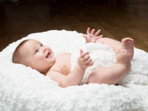 Smiling baby lying on its back