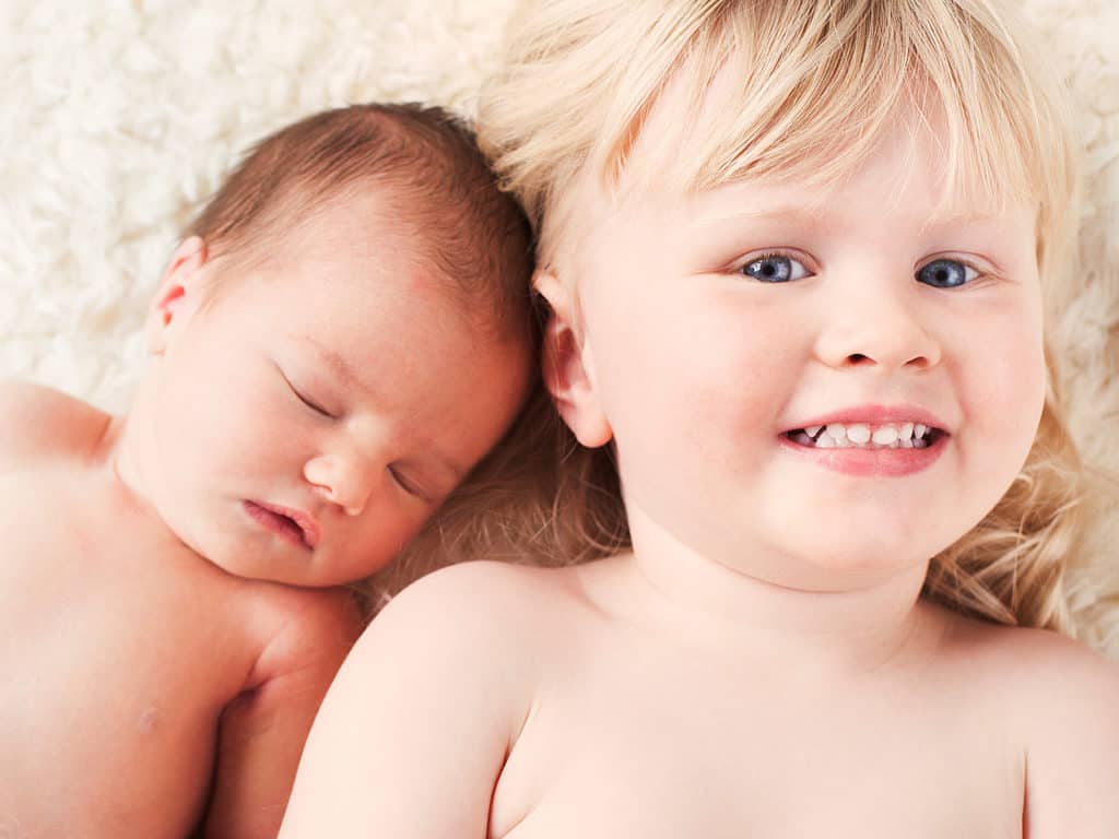 Newborn baby with toddler sister